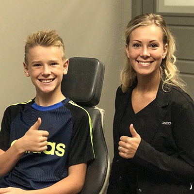 Assistant and patient giving thumbs up