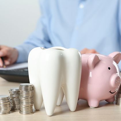 Coins next to a piggy bank
