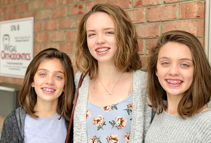 three smiling young women