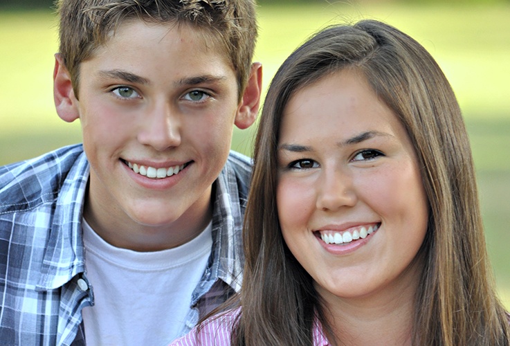 Boy and girl with straight healthy teeth