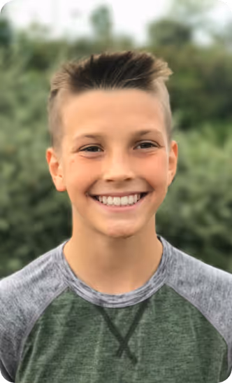 Young boy smiling outside