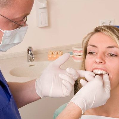 Dentist checking fit of Invisalign trays