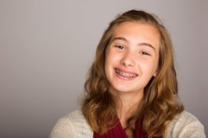 young girl blonde smiling with braces