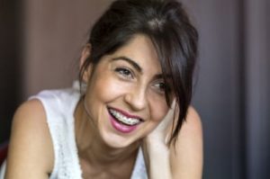 Smiling adult woman in braces 