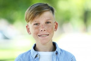 young man smiling wearing braces