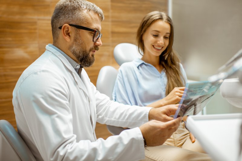 Orthodontist explaining X-ray to patient