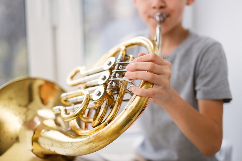 Boy playing musical instrument.
